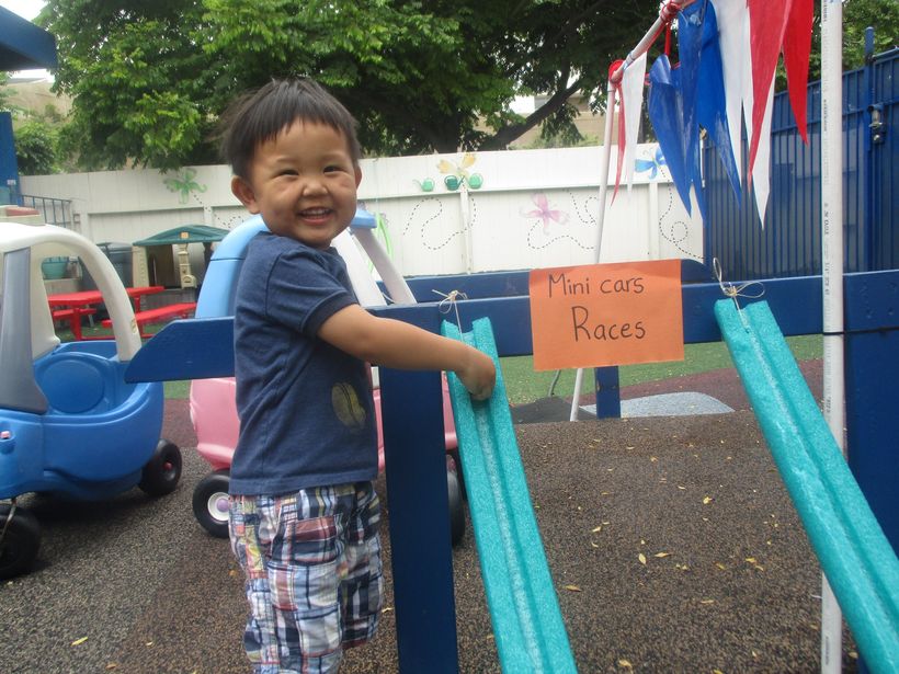A happy child going down the playground slide