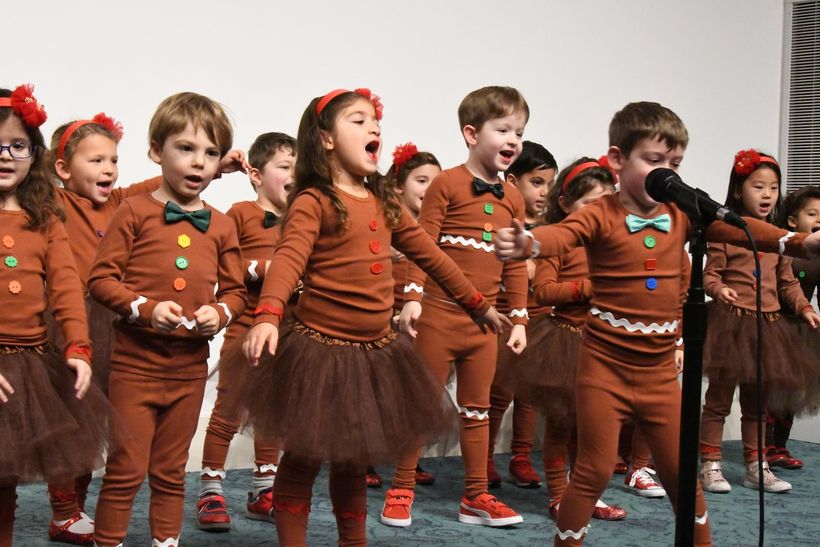 Children performing in costumes at a school show