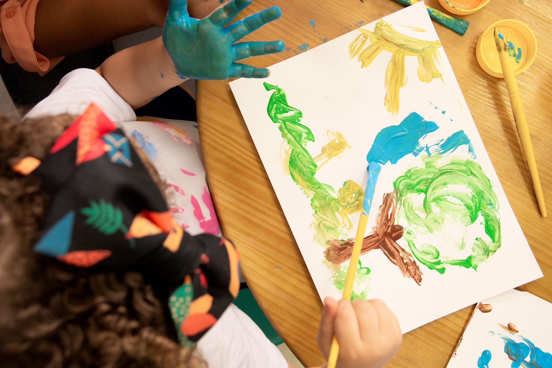 Children exploring a colorful hands-on art activity at Creative Center for Children