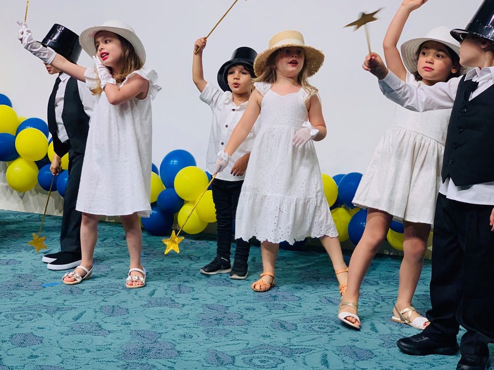 Four-year-olds performing in a school show in the Wiseowls class
